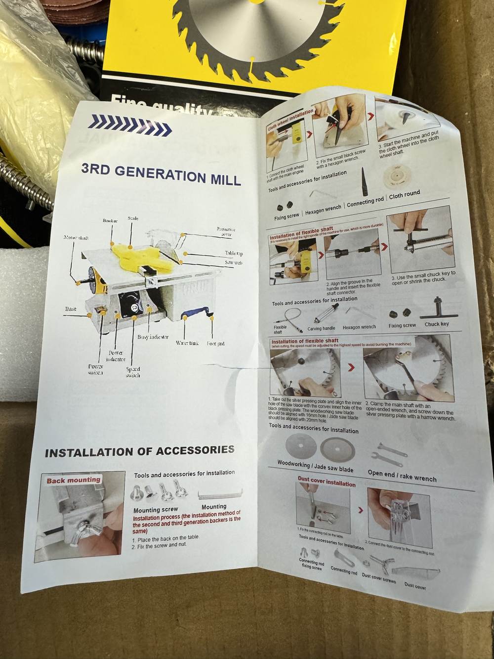 The unfolded manual for the third generation mill. A labelled diagram names the motor shaft, the table top, the saw web, the speed switch and a water tank. Below it, an installation panel headed Installation of flexible shaft shows a blade being mounted, with the note that a woodworking saw blade aligns with the 16 mm hole and a jade saw blade with the 20 mm hole, and a parts row reading Woodworking / Jade saw blade